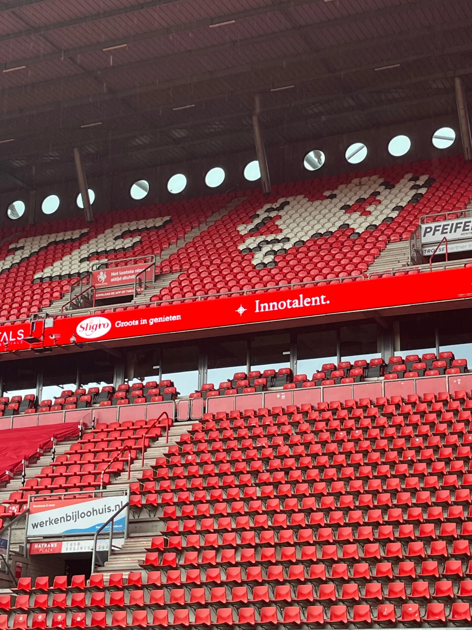 Wide view of the Grolsch Veste stand with the Innotalent boarding and the red-and-white crowd.